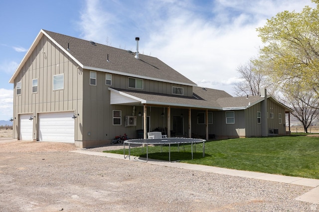 815 S Annabella Rd, Richfield, UT 84701 - view of front facade with driveway, board and batten siding, a trampoline, a front yard, and an attached garage