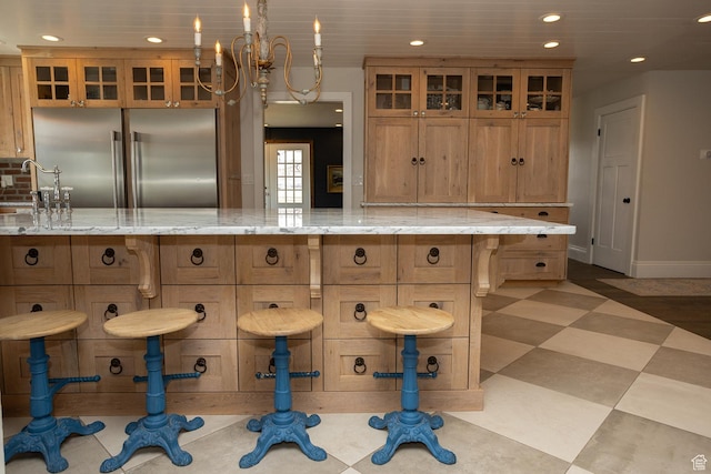 815 S Annabella Rd, Richfield, UT 84701 - kitchen featuring recessed lighting, glass insert cabinets, brown cabinetry, built in fridge, and a kitchen breakfast bar