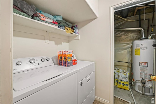 washroom featuring gas water heater, laundry area, and washing machine and clothes dryer