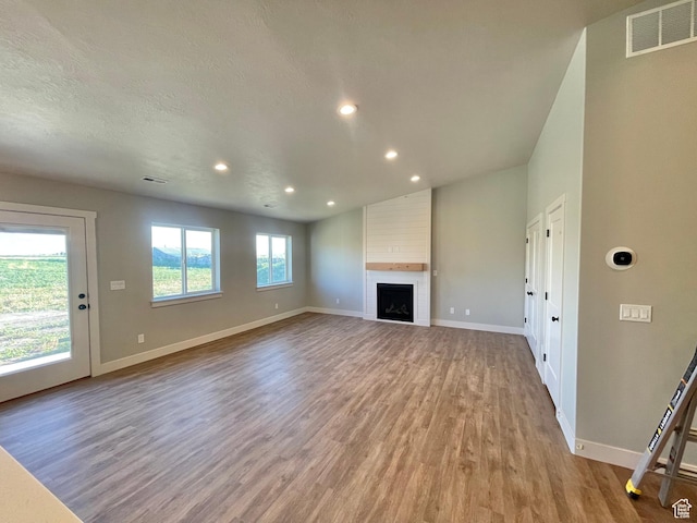 884 W Factory St, Garland, UT 84312 - unfurnished living room with baseboards, visible vents, and light wood-type flooring
