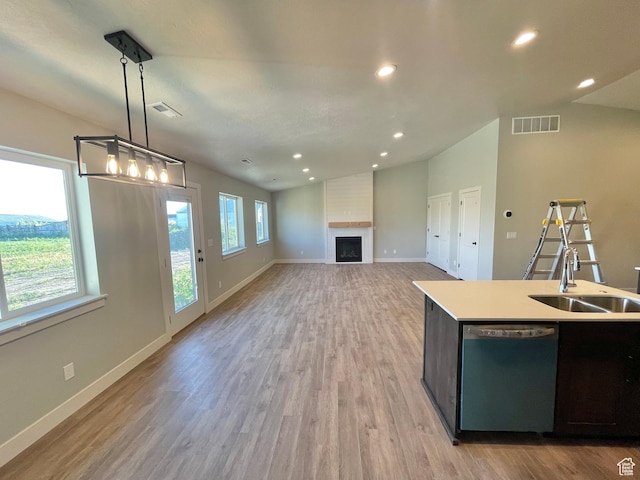 884 W Factory St, Garland, UT 84312 - kitchen featuring a sink, visible vents, light wood-style flooring, dishwasher, and lofted ceiling