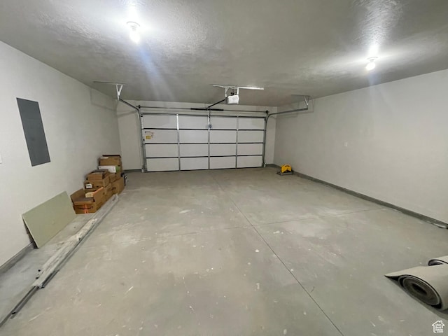 884 W Factory St, Garland, UT 84312 - garage with a garage door opener, electric panel, and baseboards