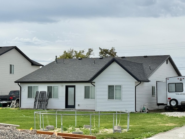 884 W Factory St, Garland, UT 84312 - back of property featuring a vegetable garden, a yard, and roof with shingles