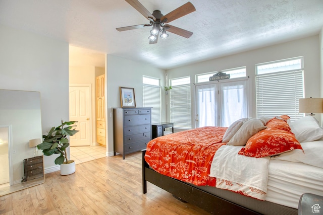 431 W 3460 N, Erda, UT 84074 - bedroom featuring ensuite bath, light wood-style floors, baseboards, a ceiling fan, and a textured ceiling