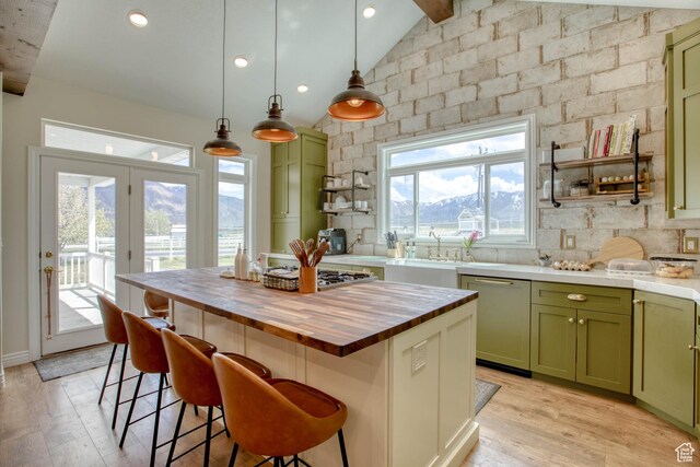 431 W 3460 N, Erda, UT 84074 - kitchen featuring light wood-style floors, wooden counters, stainless steel appliances, green cabinets, and vaulted ceiling with beams