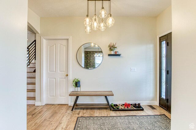 431 W 3460 N, Erda, UT 84074 - entryway featuring visible vents, stairway, wood finished floors, and a chandelier
