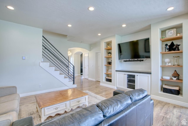 431 W 3460 N, Erda, UT 84074 - living area featuring baseboards, arched walkways, recessed lighting, light wood finished floors, and built in features