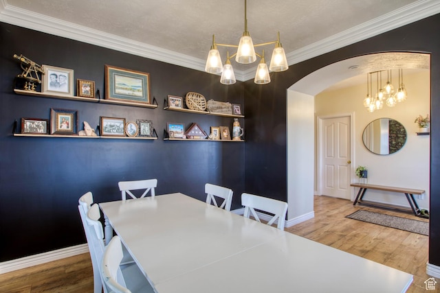 431 W 3460 N, Erda, UT 84074 - dining area with ornamental molding, baseboards, a notable chandelier, and arched walkways