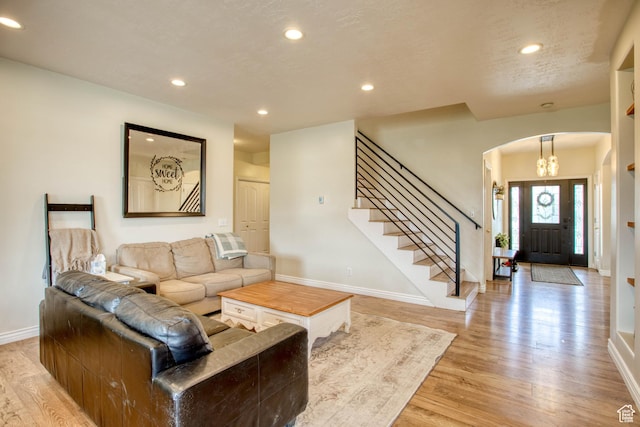431 W 3460 N, Erda, UT 84074 - living room with recessed lighting, light wood-style floors, stairs, baseboards, and arched walkways