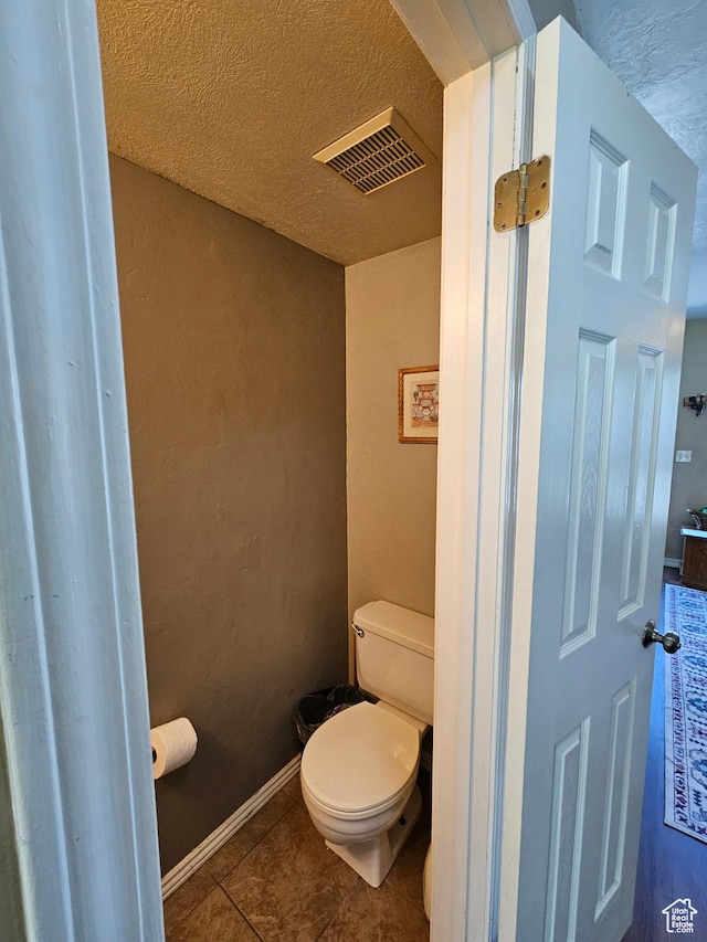 1381 W Beacon Hill Dr S, Taylorsville, UT 84123 - bathroom featuring toilet, tile patterned flooring, and a textured ceiling