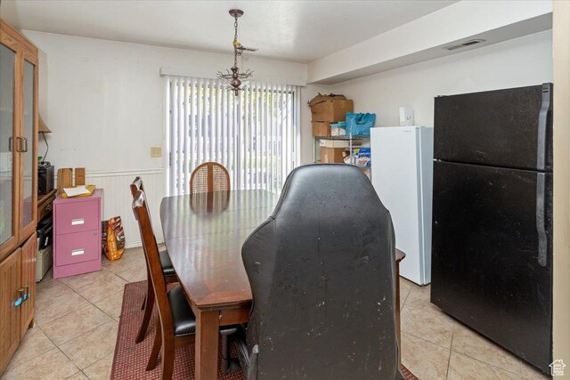 1381 W Beacon Hill Dr S, Taylorsville, UT 84123 - dining area featuring light tile patterned flooring and wainscoting