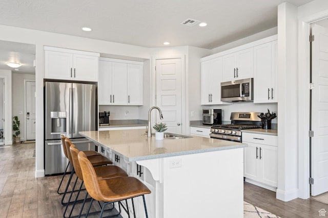 1378 N Marfil Way, Washington, UT 84780 - kitchen with wood finished floors, a kitchen bar, stainless steel appliances, and a sink