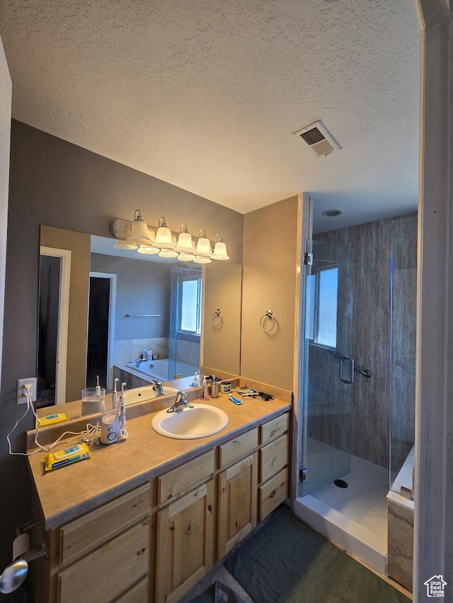 5564 S Yellow Fin Way W, Murray, UT 84107 - bathroom featuring a textured ceiling, a shower stall, visible vents, a garden tub, and vanity