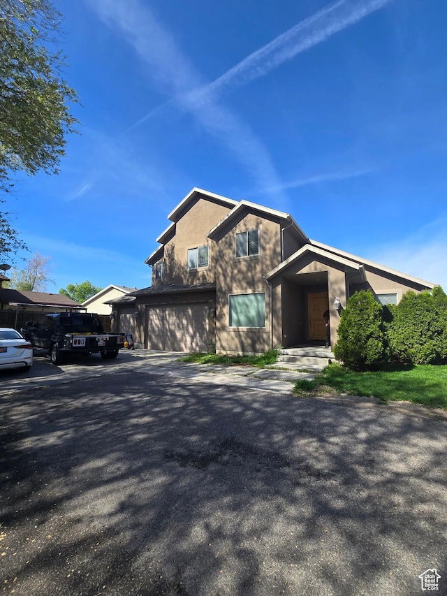 view of front of property with stucco siding and an attached garage