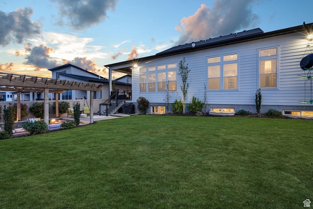 4772 W Thorntree Ln, Herriman, UT 84096 - back of property at dusk with a patio area, a yard, and a pergola