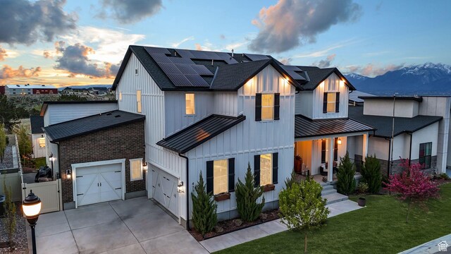 4772 W Thorntree Ln, Herriman, UT 84096 - modern inspired farmhouse with a standing seam roof, metal roof, solar panels, roof with shingles, and concrete driveway