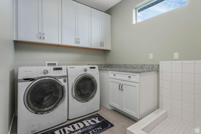 4772 W Thorntree Ln, Herriman, UT 84096 - laundry area with light tile patterned flooring, cabinet space, and independent washer and dryer