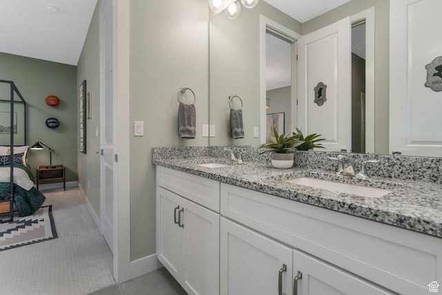4772 W Thorntree Ln, Herriman, UT 84096 - ensuite bathroom with tile patterned floors, baseboards, double vanity, and a sink