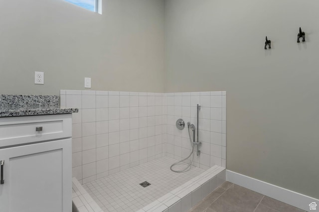 4772 W Thorntree Ln, Herriman, UT 84096 - bathroom with tile patterned floors, baseboards, tiled shower, and vanity