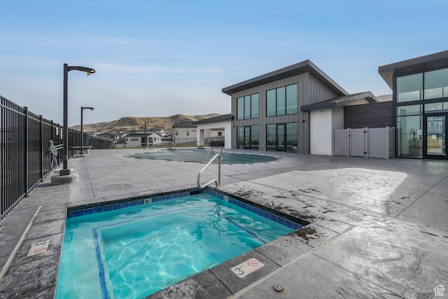 4772 W Thorntree Ln, Herriman, UT 84096 - view of pool with a mountain view, fence, a hot tub, and a patio area
