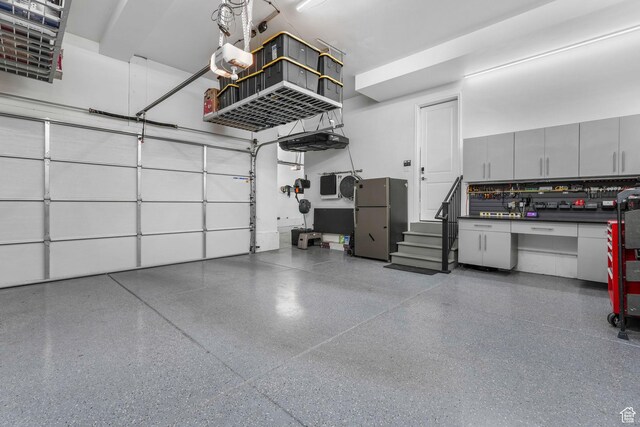 4772 W Thorntree Ln, Herriman, UT 84096 - garage featuring a garage door opener and freestanding refrigerator