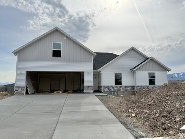 62 N 900 W, Garland, UT 84312 - modern farmhouse style home with driveway, a garage, and stone siding
