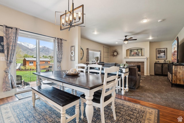 1030 S Barley Ln, Kaysville, UT 84037 - dining room featuring recessed lighting, wood finished floors, ceiling fan with notable chandelier, a mountain view, and a fireplace