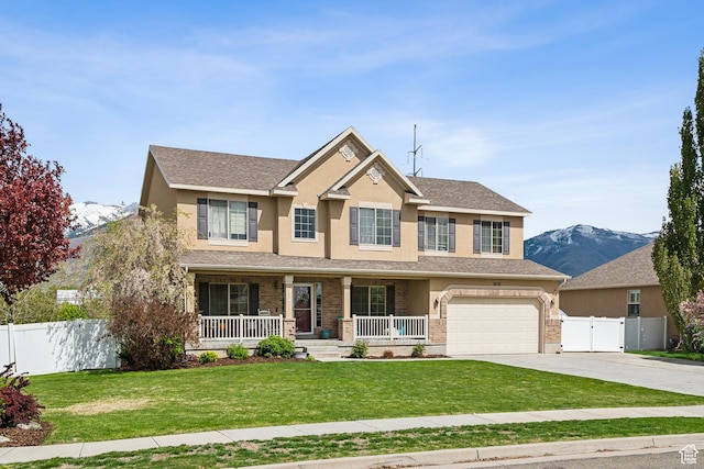 1030 S Barley Ln, Kaysville, UT 84037 - craftsman house with driveway, stucco siding, covered porch, a front yard, and fence