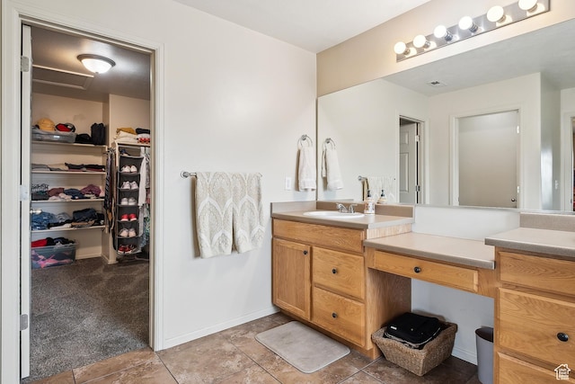 1030 S Barley Ln, Kaysville, UT 84037 - bathroom featuring a walk in closet, baseboards, vanity, and visible vents