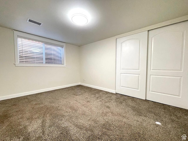 unfurnished bedroom featuring baseboards, visible vents, a closet, and carpet flooring