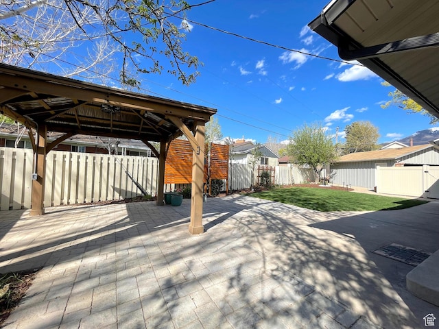 view of patio featuring a residential view, a gazebo, and a fenced backyard