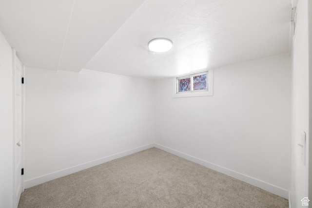 below grade area featuring baseboards and carpet floors