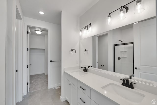 4099 W 2025 S Unit 51, Taylor, UT 84401 - bathroom with a tile shower, double vanity, a spacious closet, tile patterned floors, and recessed lighting