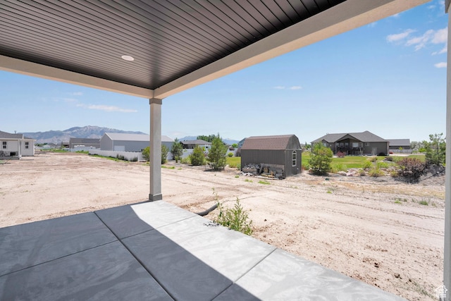 4099 W 2025 S Unit 51, Taylor, UT 84401 - view of patio / terrace with a residential view, a storage unit, and a mountain view