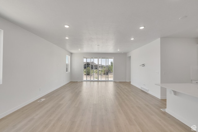 4099 W 2025 S Unit 51, Taylor, UT 84401 - unfurnished living room with recessed lighting and light wood-type flooring