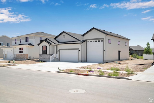 4099 W 2025 S Unit 51, Taylor, UT 84401 - view of front facade featuring a garage, driveway, and stucco siding