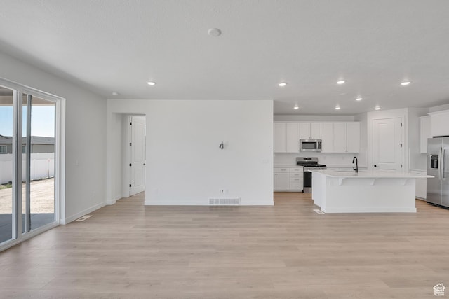 4099 W 2025 S Unit 51, Taylor, UT 84401 - unfurnished living room featuring recessed lighting and light wood-style flooring