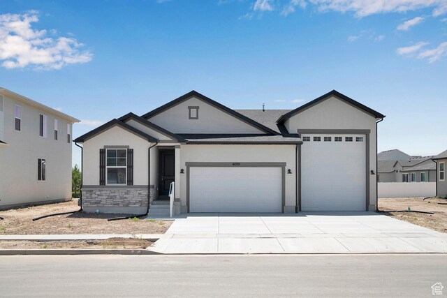 4099 W 2025 S Unit 51, Taylor, UT 84401 - ranch-style house featuring an attached garage, stucco siding, driveway, and stone siding