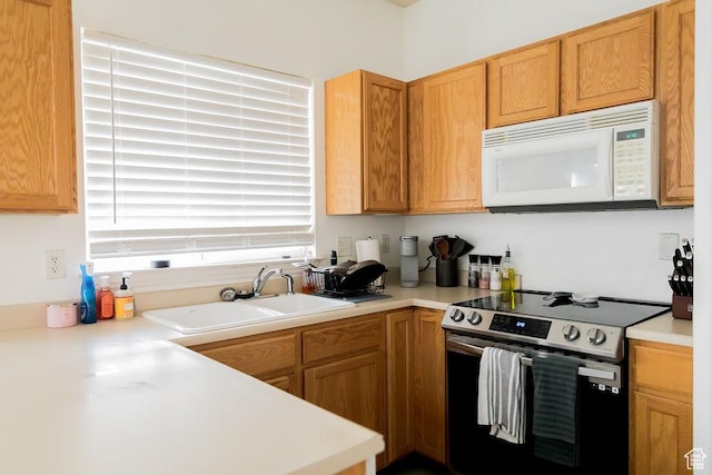 4112 W 4645 S, West Valley City, UT 84120 - kitchen featuring light countertops, stainless steel range with electric stovetop, white microwave, and a sink