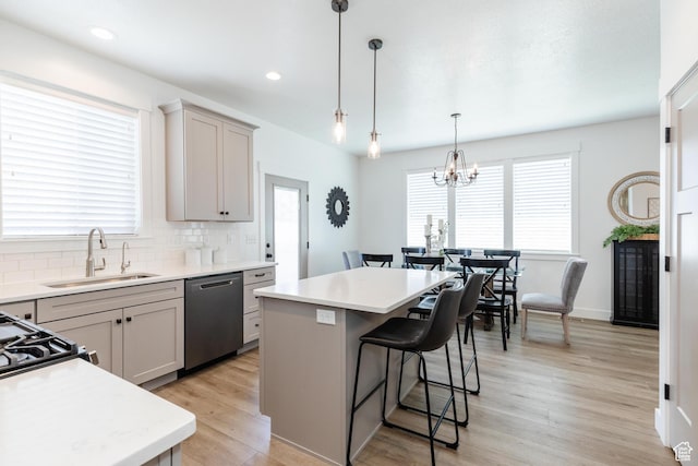 1076 E 300 S, Smithfield, UT 84335 - kitchen featuring a kitchen bar, a center island, light countertops, a sink, and dishwasher