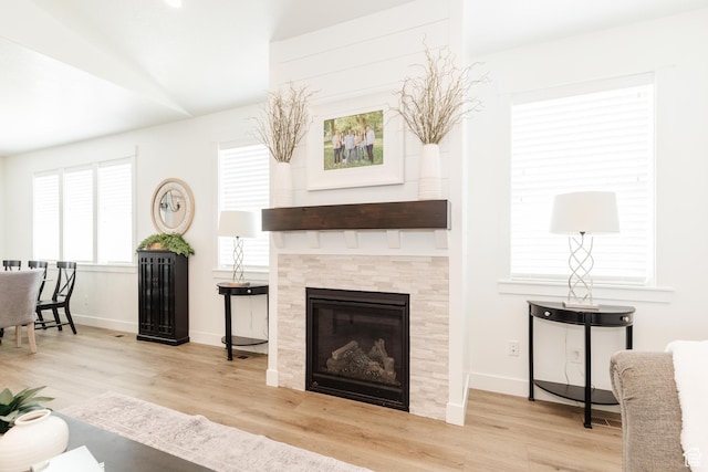 1076 E 300 S, Smithfield, UT 84335 - living room featuring a tiled fireplace, baseboards, wood finished floors, and vaulted ceiling