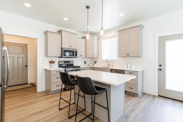 1076 E 300 S, Smithfield, UT 84335 - kitchen with a sink, appliances with stainless steel finishes, a kitchen breakfast bar, and tasteful backsplash