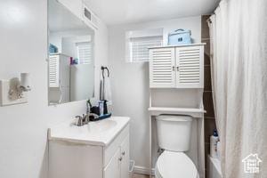 2959 S 9200 W, Magna, UT 84044 - bathroom featuring toilet, baseboards, vanity, and a shower with shower curtain
