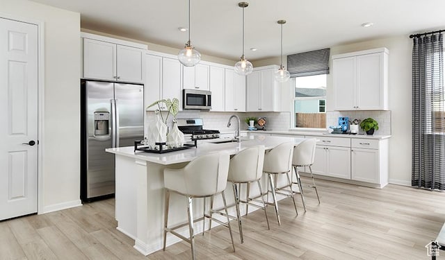 2074 S 3940 W Unit 11, Taylor, UT 84401 - kitchen with stainless steel appliances, a sink, light wood finished floors, backsplash, and light countertops