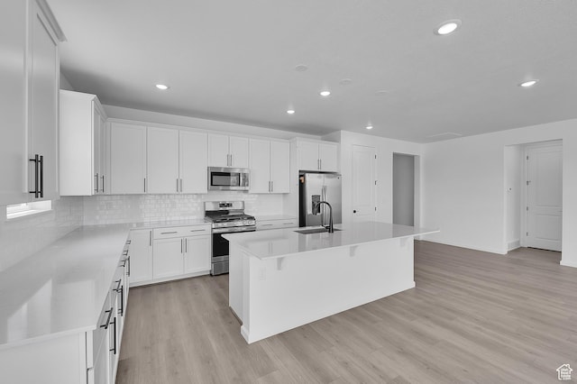 2074 S 3940 W Unit 11, Taylor, UT 84401 - kitchen with stainless steel appliances, tasteful backsplash, white cabinetry, a kitchen island with sink, and recessed lighting