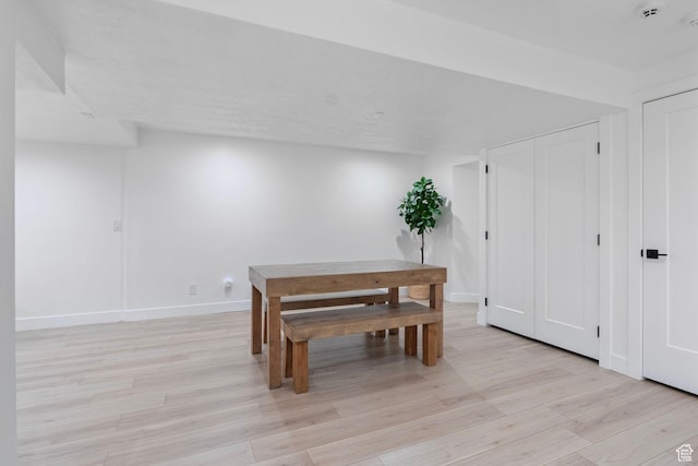 dining room with baseboards and light wood-type flooring