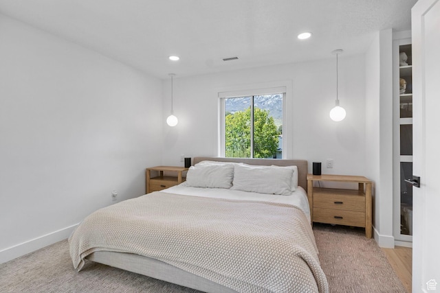 bedroom with recessed lighting, visible vents, light wood-style flooring, and baseboards