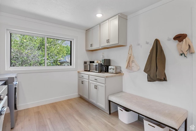 mudroom with recessed lighting, baseboards, and light wood-type flooring