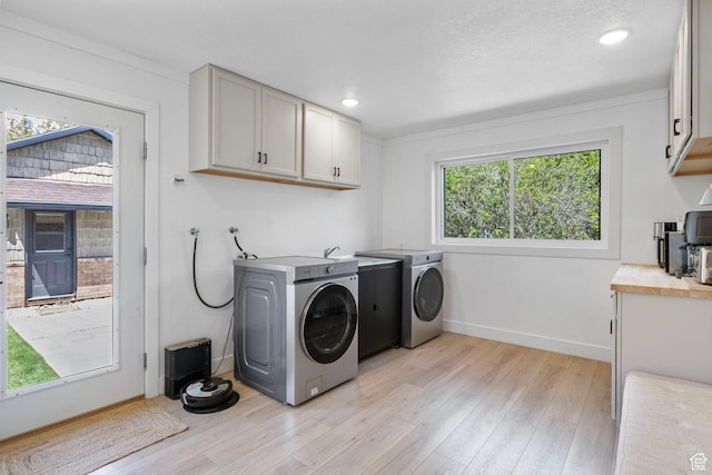 laundry area featuring baseboards, washer and dryer, light wood-type flooring, recessed lighting, and cabinet space