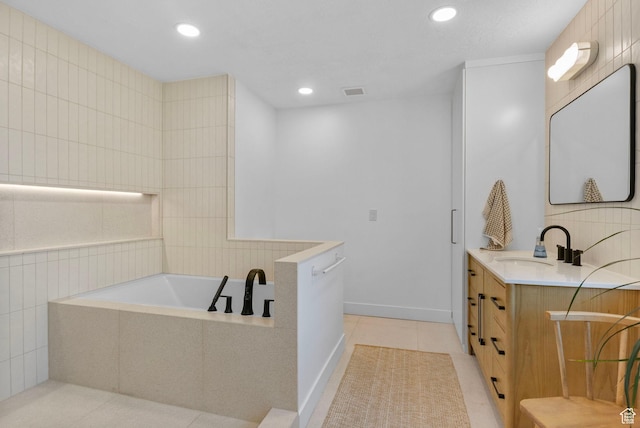 full bath featuring vanity, recessed lighting, a bath, and tile patterned flooring